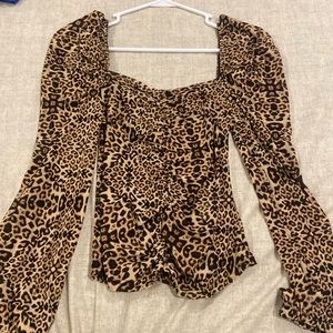 Leopard print blouse with slight puff in sleeve and ruche down middle